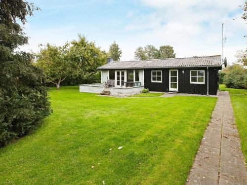 a house with a large yard in front of it at 6 person holiday home in Dronningm lle in Dronningmølle