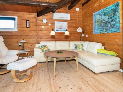 a living room with a couch and a table at 6 person holiday home in Glesborg in Fjellerup