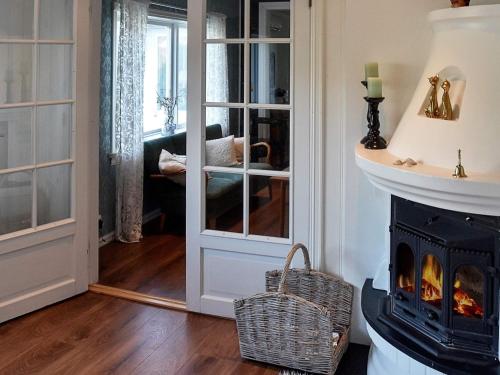a living room with a fireplace and a stove at 10 person holiday home in Folkestad in Folkestad