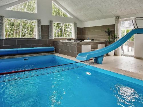 a large swimming pool with a slide in a bathroom at Holiday home Kappeln XIII in Kappeln