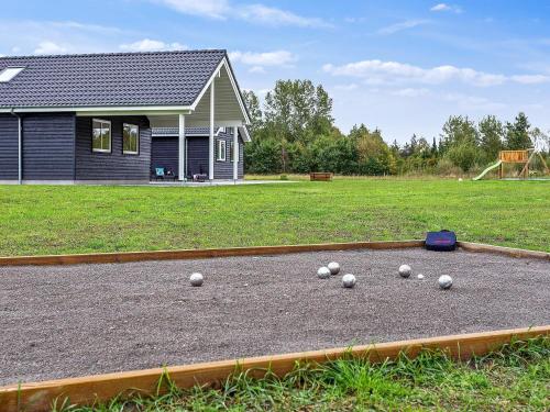 a bunch of balls on the ground in front of a house at 20 person holiday home in V ggerl se in Marielyst