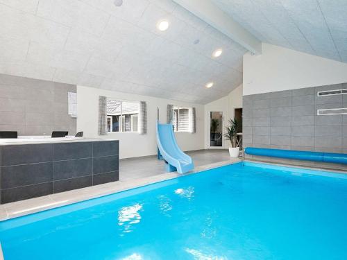 a swimming pool with a slide in a building at 20 person holiday home in V ggerl se in Marielyst