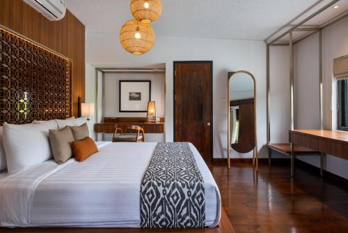 a bedroom with a large bed and a piano at Zenubud in Ubud