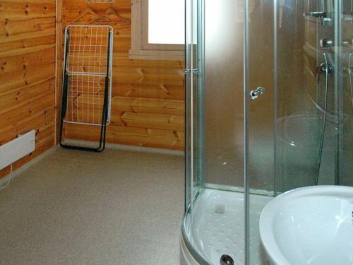 a bathroom with a shower and a sink at 5 person holiday home in VÅGLAND in Bårdset
