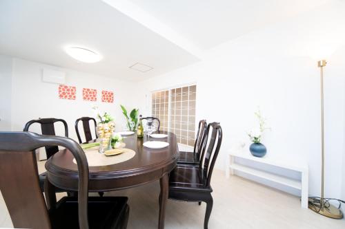 a dining room with a table and chairs at Awaji Central Villa in Shizuki1764 in Awaji