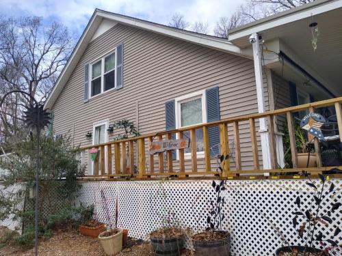 a house with a wooden deck on top of it at Serenity Hill b&b in Sloans Crossing