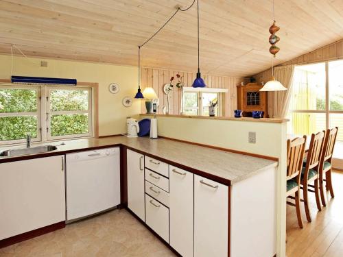 a kitchen with white cabinets and a counter top at 6 person holiday home in Hemmet in Hemmet