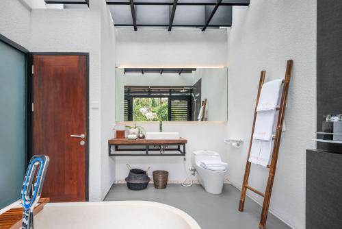 a bathroom with a toilet and a sink at Zenubud in Ubud