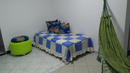 a room with a bed and a hammock at Casa na praia de Aruana in Atalaia Velha