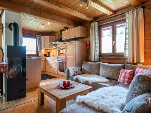 a living room with a couch and a table at Chalet in Kirchberg with terrace and garden in Aschau