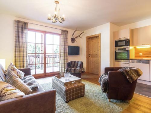 a living room with a couch and a table at Holiday home with snow covered views in Hollersbach im Pinzgau