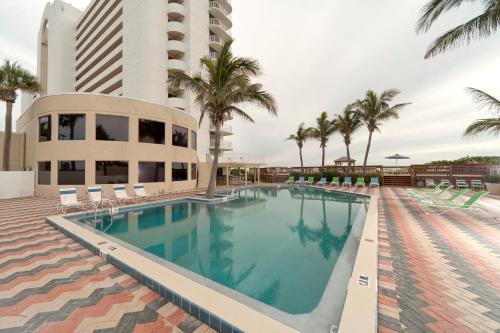 a large swimming pool in front of a building at Radisson Suite Hotel Oceanfront in Melbourne