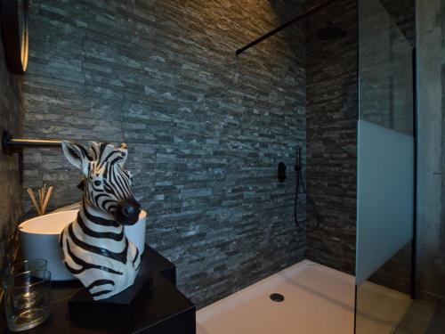 a zebra statue sitting on a table in a bathroom at Dalhem Villa with Garden in Dalhem