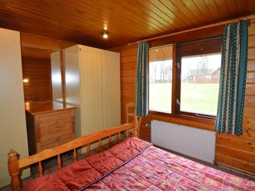 a bedroom with a bed and a window at Group Retreat in Robertville in Ovifat