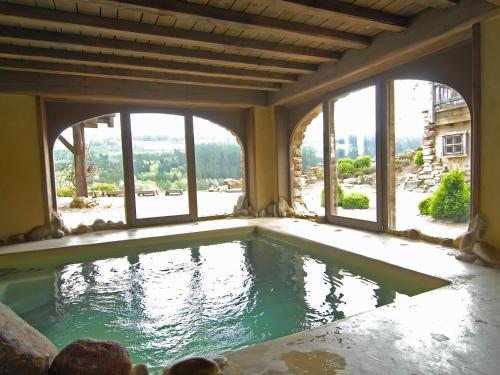 una gran piscina en un edificio con ventanas en Opulent Chalet in Thirimont with Turkish Steambath, en Waimes