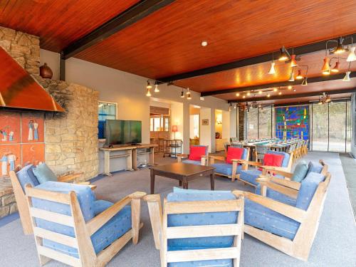 a living room with blue chairs and a tv at Lavish Holiday Home in Fauvillers with Garden in Fauvillers