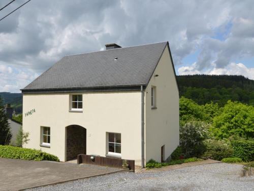 a white house with a black roof at Apartment with private garden in the heights of Bouillon in Bouillon