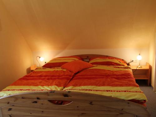a bedroom with a bed with two lamps on it at Wohnung mit großem Garten an der Ostseeküste in Neubukow