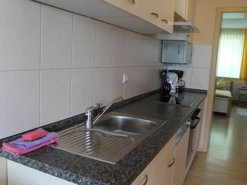 a kitchen with a sink and a counter top at Pretty Apartment in Wiek with Garden in Wiek auf Rügen 