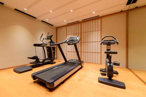 a gym with three exercise bikes in a room at NISEKO Inn of Youtei Raku Suisan in Kutchan