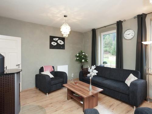 a living room with a couch and a table at Holiday home near ski area in Rechenberg-Bienenmühle