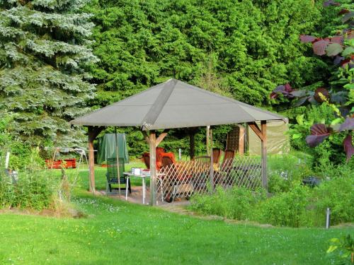 a gazebo in the middle of a garden at Attractive Holiday Home in Rotenburg with Garden in Dankerode