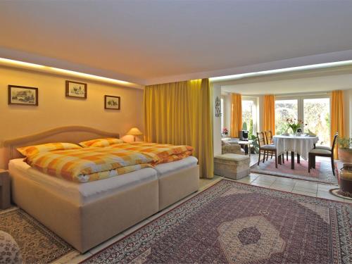 a bedroom with a bed and a dining room at Attractive apartment in Bellenberg with garden in Horn-Bad Meinberg