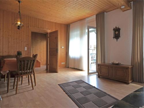 a living room with a table and a dining room at Apartment in Sauerland with terrace in Helminghausen