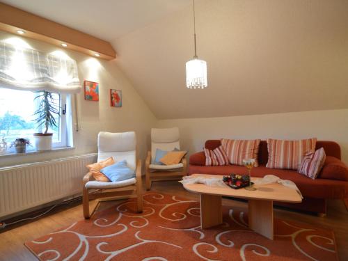 a living room with a couch and two chairs and a table at Apartment on the Moselle in Neumagen Dhron in Neumagen-Dhron