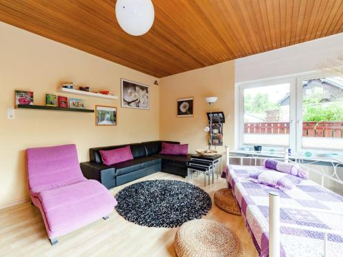 a living room with a couch and a table at Dog friendly holiday home in Hesse with garden in Bad Zwesten