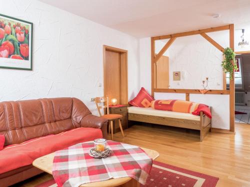 a living room with a couch and a table at Flat in Herrischried Black Forest in Herrischried