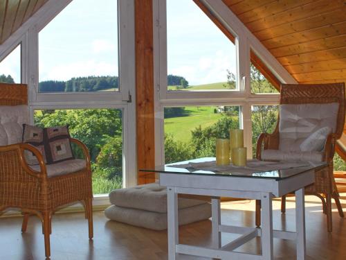 a room with a table and chairs and a window at Beautiful apartment near the lake in Herrischried