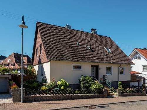 a white house with a brown roof at Cheerful apartment near city centre of Haslach in Haslach im Kinzigtal
