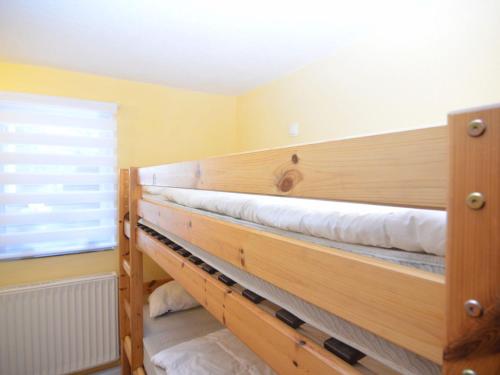 two bunk beds in a room with a window at Beautiful holiday home in the Thuringian Forest with fireplace and whirlpool in Schnett