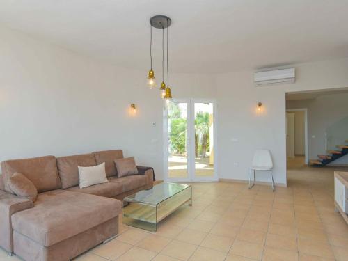 a living room with a couch and a glass table at Villa in Moraira with Pool near Beach in Moraira