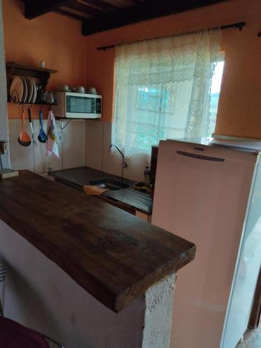 a kitchen with a counter top and a refrigerator at Pouso do Elefante in Serra do Cipo