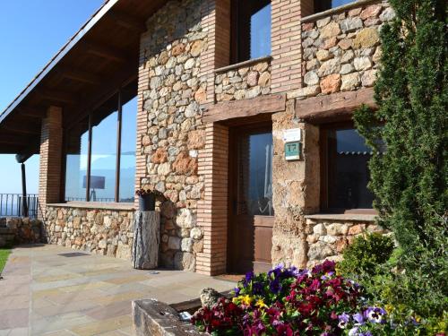 a stone building with flowers in front of it at Belvilla by OYO Cobert de l Era in Oden