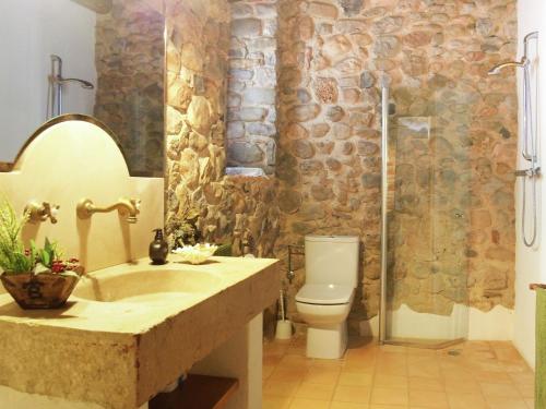 a bathroom with a sink and a toilet and a shower at Spacious Home in Navata in Navata