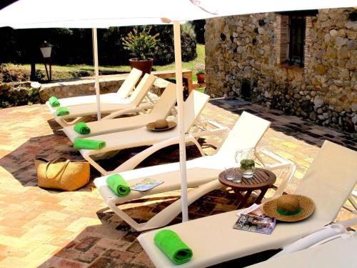 a group of chairs and an umbrella on a patio at Spacious Home in Navata in Navata