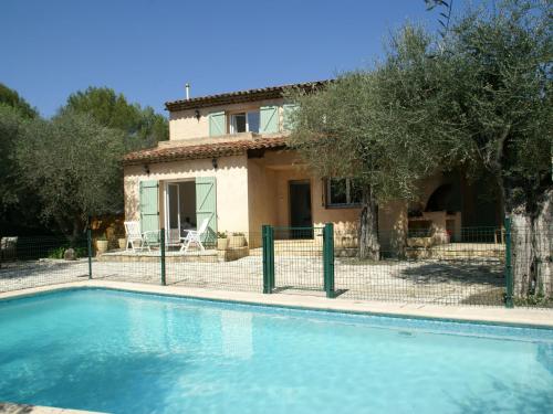a villa with a swimming pool in front of a house at Spacious villa with garden near Grasse in Mouans-Sartoux