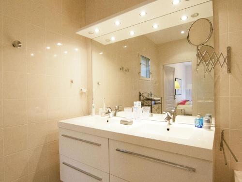 a bathroom with a sink and a large mirror at Rouzède Villa with Pool in Rouzède