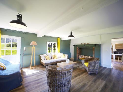 a living room with a couch and a table at Castle and its outbuildings with terrace in Asni res in Asnières