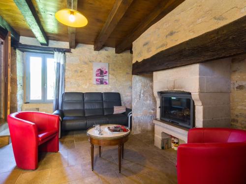 a living room with a couch and a fireplace at Holiday Home in Th mines with Private Pool in Issendolus