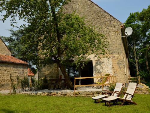 a group of chairs in front of a building at Holiday home with private garden in Wierre Effroy in Rinxent