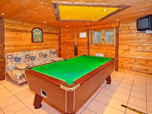 a living room with a pool table in a cabin at Luxurious Chalet in Champagny en Vanoise near Ski Area in Champagny-en-Vanoise