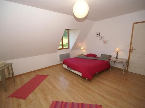a bedroom with a red bed in a attic at Cottage in Flainville near Norman Coastline in Le Bourg-Dun