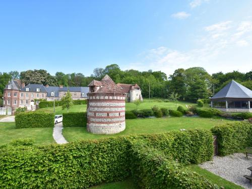 a view of a garden with a brick chimney at Cottage in Flainville near Norman Coastline in Le Bourg-Dun
