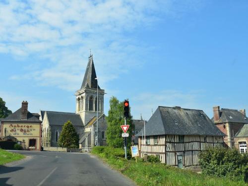 an old village with a church and a red traffic light at Cottage in Flainville near Norman Coastline in Le Bourg-Dun