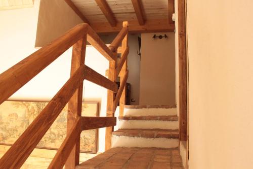 a staircase in a house with wooden beams at Chiesa Ignano 1778 in Marzabotto
