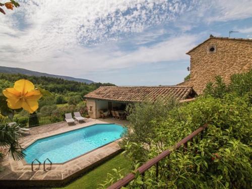 a swimming pool in front of a house at Magnificent holiday home with pool in Oppède